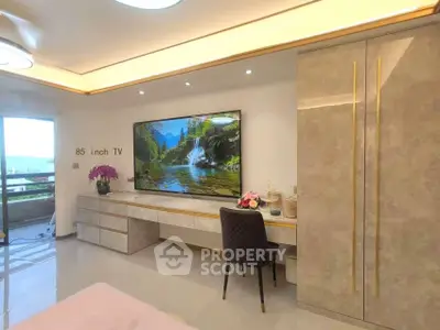 Luxurious living room with 85 inch TV and elegant decor, featuring a scenic balcony view.