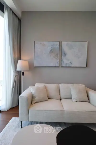 Elegant living room with modern sofa and abstract art, perfect for stylish urban living.