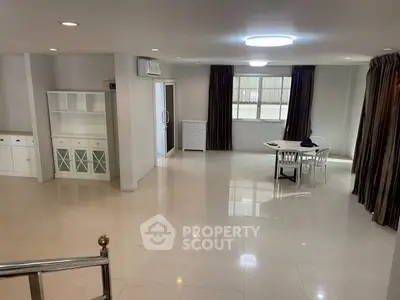 Spacious living room with modern furniture and large windows for natural light