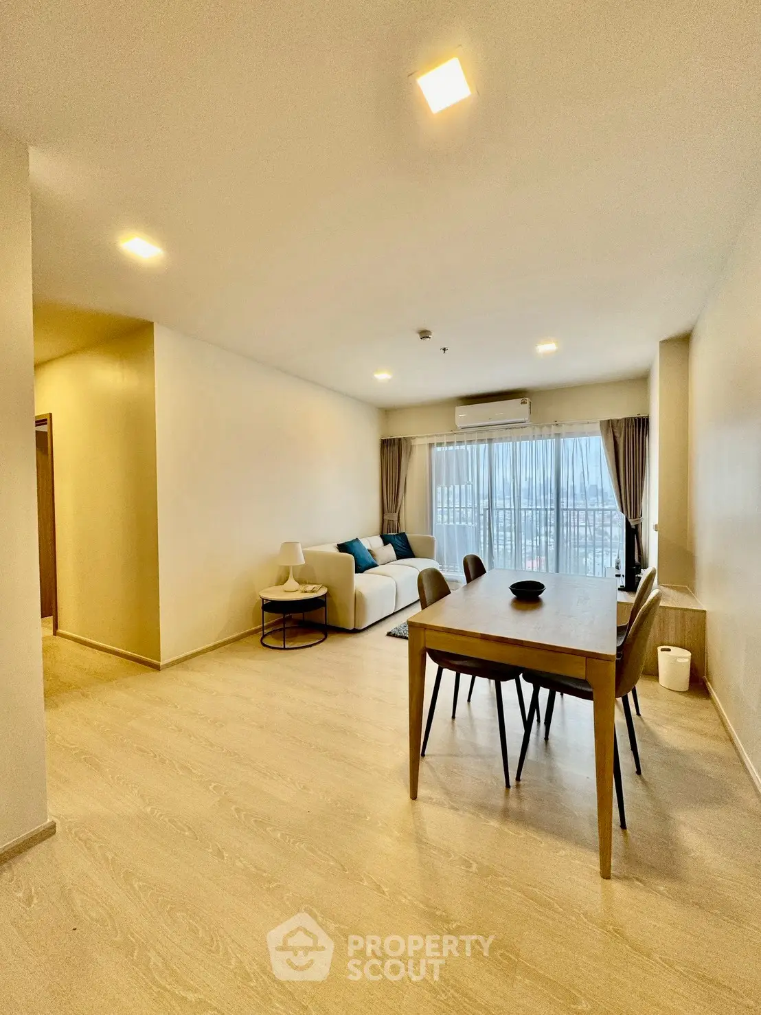 Spacious modern living room with dining area and large windows