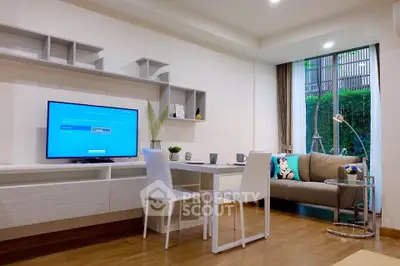 Modern living room with sleek furniture and large window overlooking greenery, perfect for relaxation.