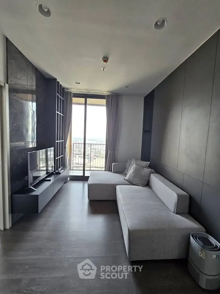 Modern living room with sleek design and large window offering a stunning view.