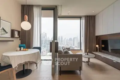 Modern living room with city view, stylish furniture, and open layout in a high-rise apartment.