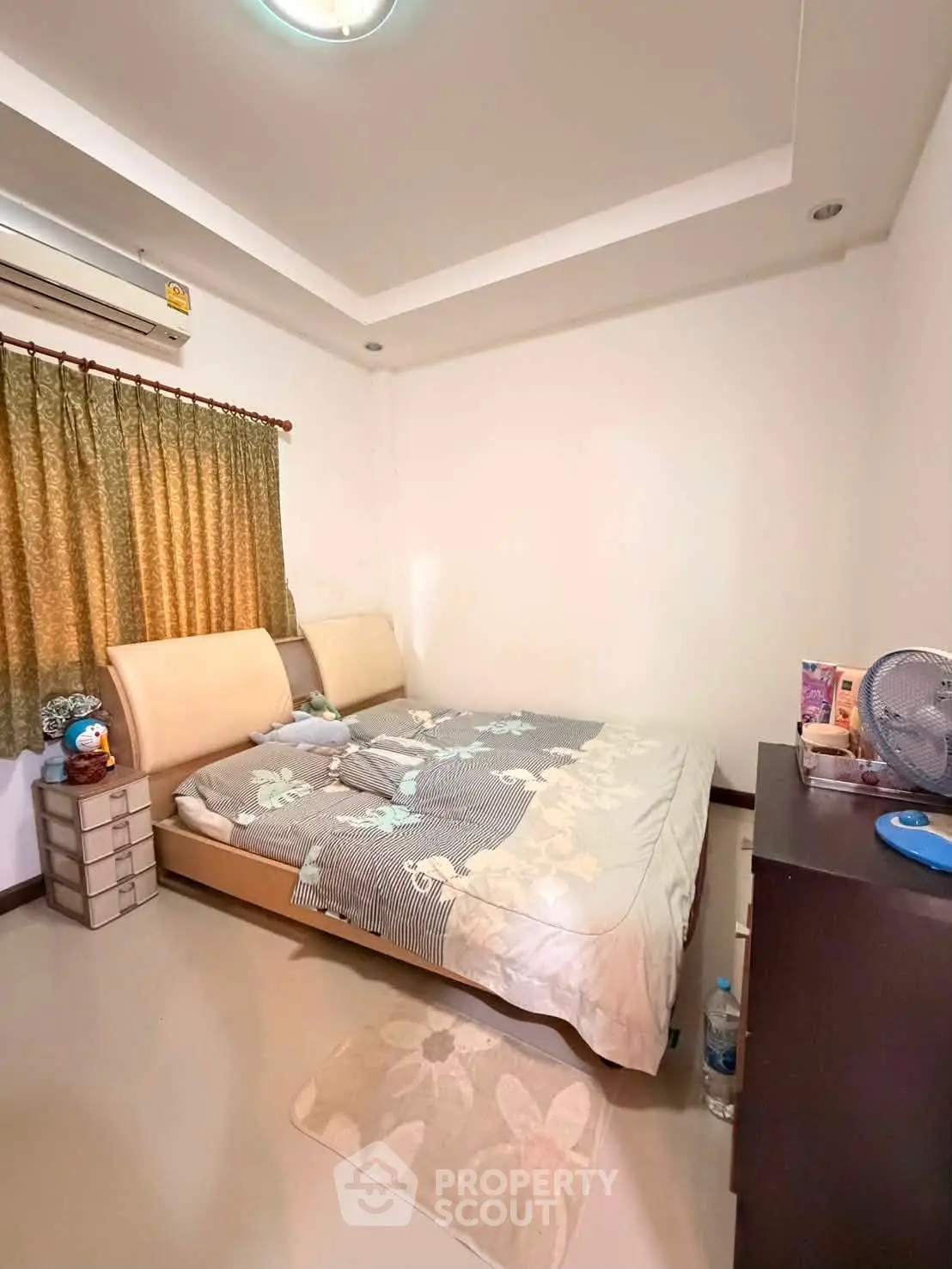Cozy bedroom with modern decor and ample natural light, featuring a comfortable bed and stylish furnishings.