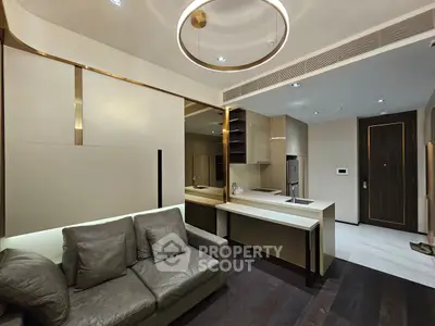 Modern open-layout living room with sleek kitchen design and elegant lighting