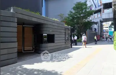 Modern building entrance with sleek design and urban surroundings