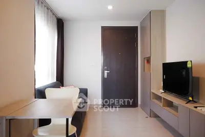 Modern living room with sleek furniture and natural light, perfect for cozy urban living.