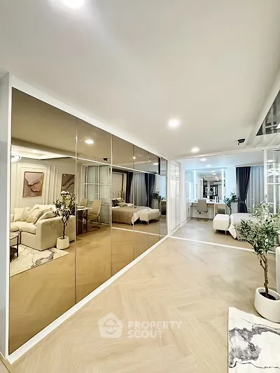 Spacious modern living room with mirrored wall and elegant decor