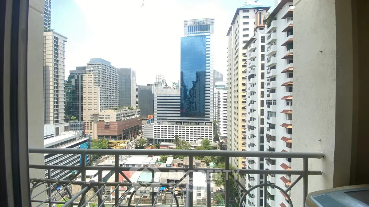 Stunning cityscape view from a high-rise balcony in a bustling urban area.