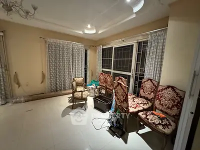 Spacious living room with elegant chairs and large windows for natural light