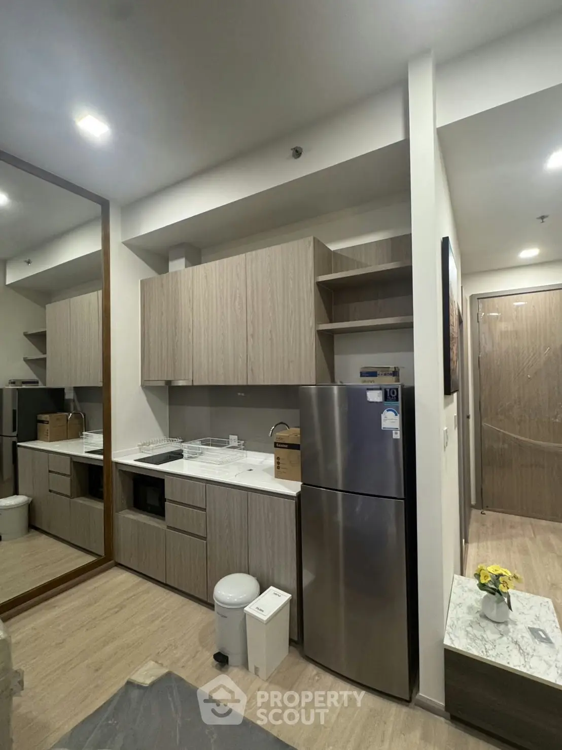 Modern kitchen with sleek cabinetry and stainless steel appliances in a contemporary apartment.