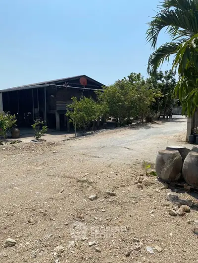 Rustic rural property with spacious outdoor area and lush greenery, perfect for serene living or farming.