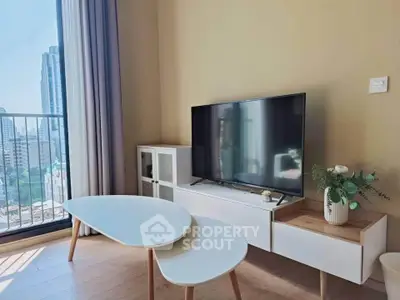 Modern living room with city view, stylish furniture, and natural light.