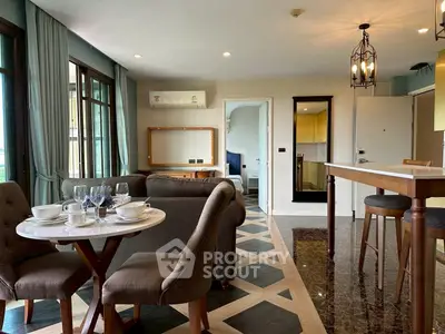 Spacious open-plan living room with elegant dining area and modern decor.