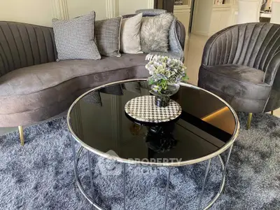 Luxurious living room with plush gray furniture and elegant decor