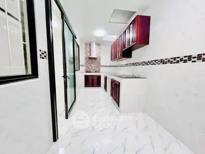 Sleek modern kitchen with elegant cabinetry and tiled flooring