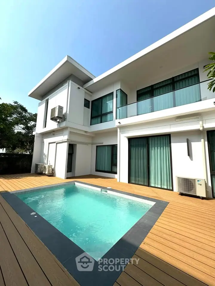 Modern two-story house with private pool and spacious deck area.