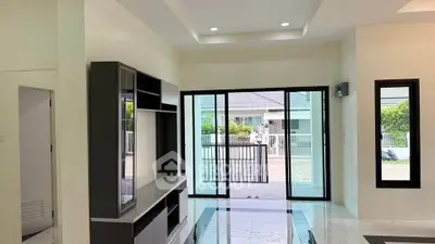 Spacious living room with modern design and large sliding glass doors leading to a patio.