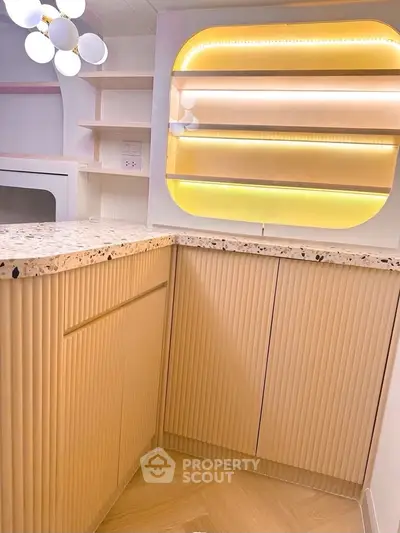 Modern kitchen with elegant lighting and stylish cabinetry