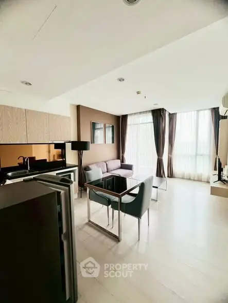 Modern living room with sleek furniture and large windows in a stylish apartment.