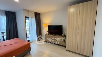 Modern bedroom with stylish furniture and natural light, featuring a cozy bed and sleek wardrobe.