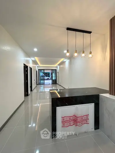 Modern open layout with sleek lighting and glossy flooring