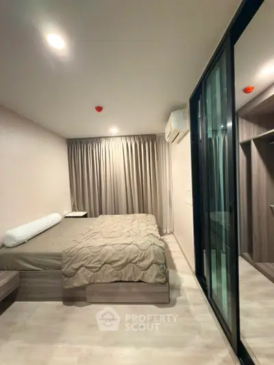 Modern bedroom with sleek design and ample natural light, featuring a comfortable bed and stylish decor.