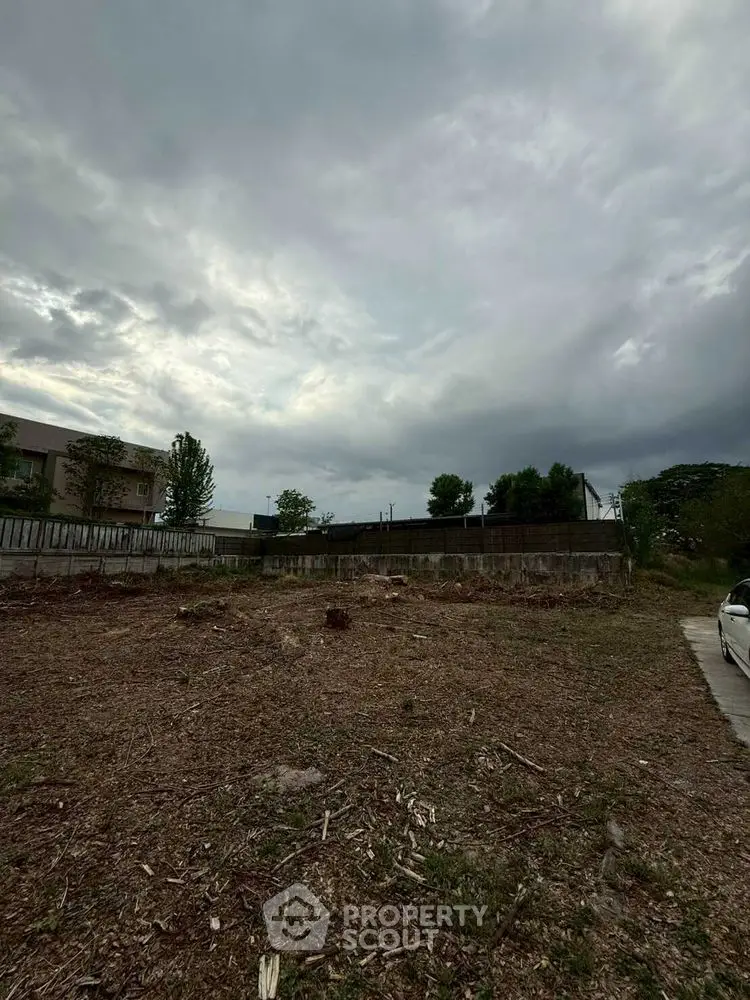 Vacant land plot with cloudy sky, ideal for new construction or investment opportunity.