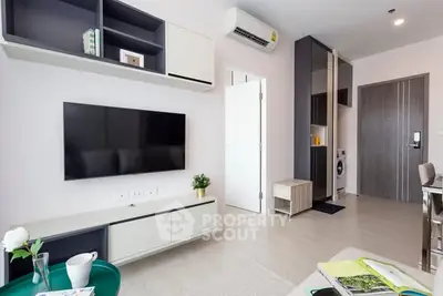 Modern living room with sleek furniture and wall-mounted TV in stylish apartment.