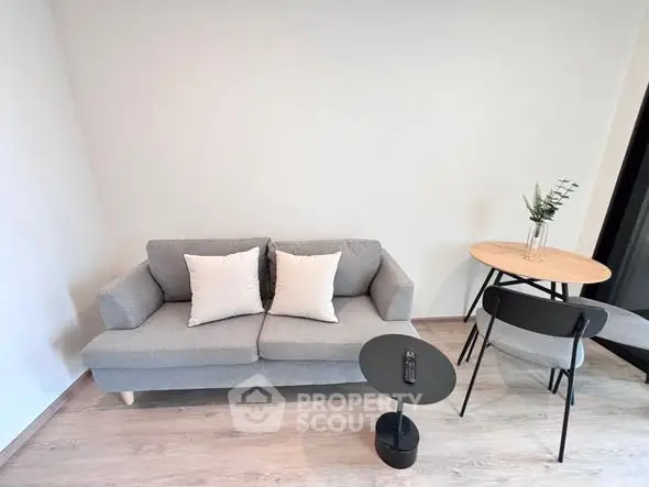 Modern living room with stylish gray sofa and minimalist decor
