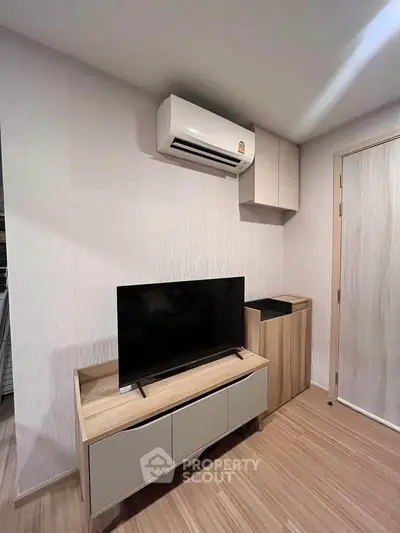Modern living room with sleek TV stand and air conditioning unit