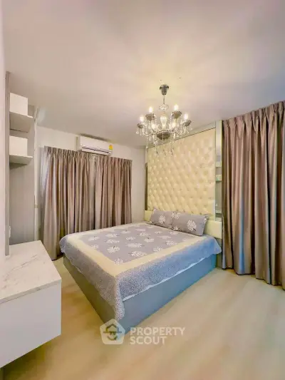 Luxurious bedroom with elegant chandelier and plush decor