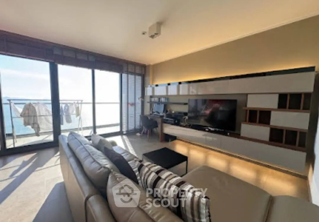 Spacious living room with modern decor and stunning balcony view.