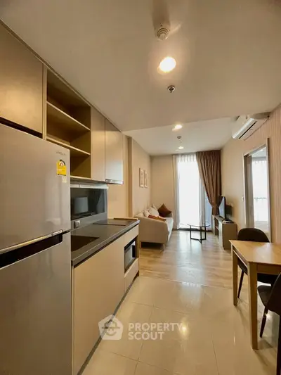 Modern open-layout kitchen and living room with sleek design and natural light