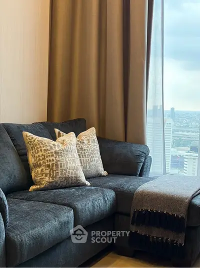 Stylish living room with plush sofa and city view from large window