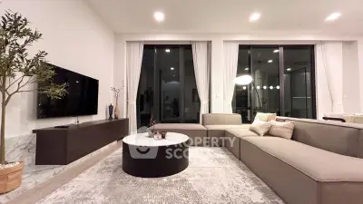 Luxurious modern living room with sleek furniture and large windows.