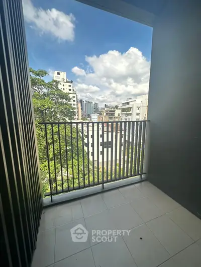 Charming urban balcony with city skyline view, perfect for relaxation and enjoying the outdoors.
