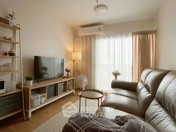 Cozy living room with leather sofa and modern decor, perfect for relaxation.