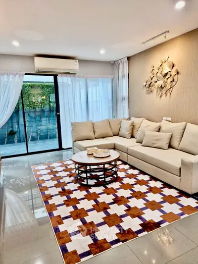 Spacious living room with modern decor and large windows offering natural light.