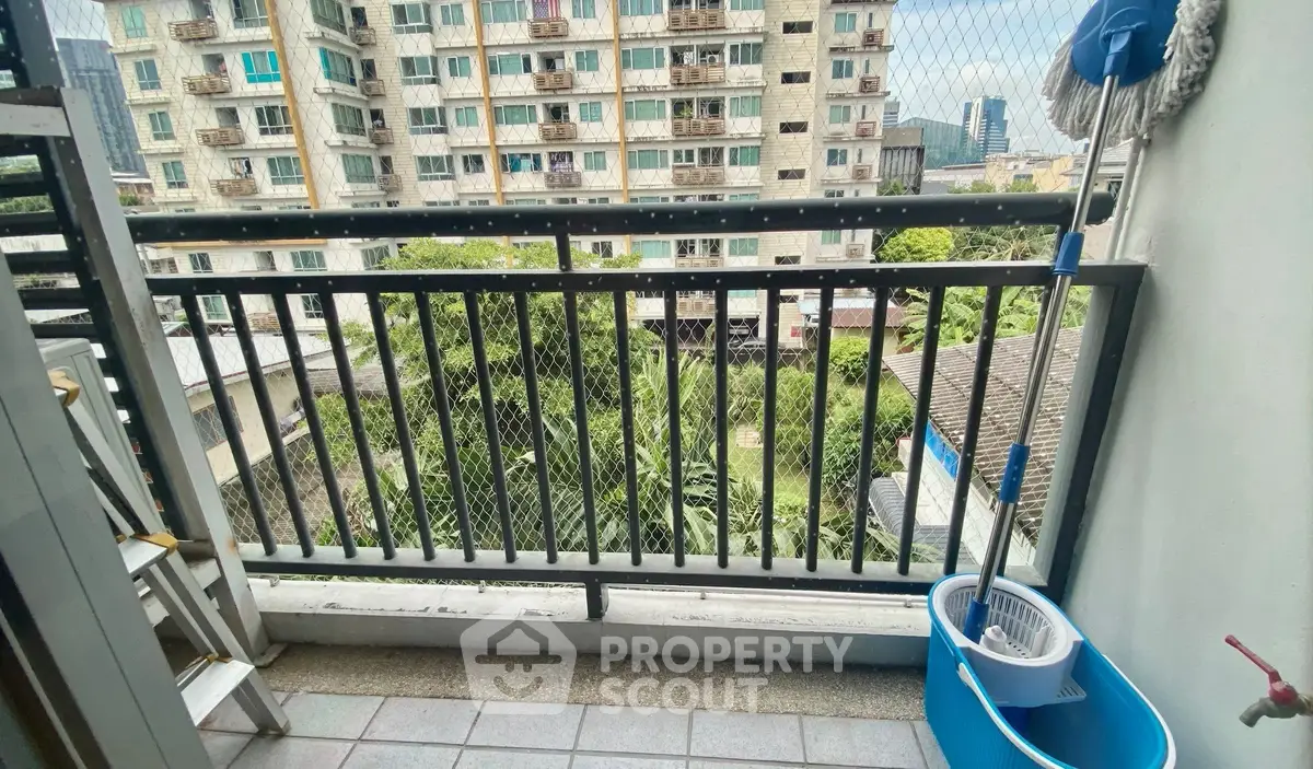 Charming balcony with city view and greenery, perfect for relaxation.