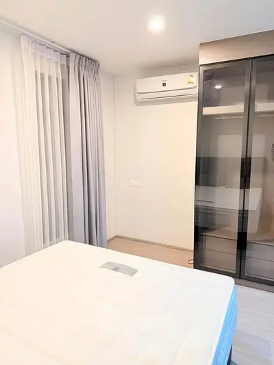 Modern bedroom with air conditioning and sleek wardrobe design