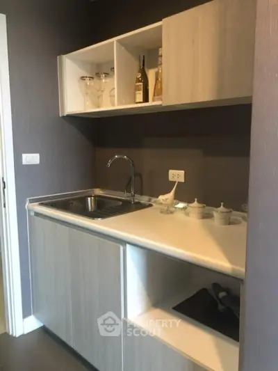 Modern compact kitchen with sleek cabinetry and stylish open shelving.