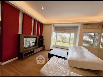 Spacious living room with modern decor and large windows offering a bright and airy atmosphere.