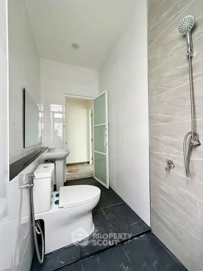 Modern bathroom with sleek design and shower area in contemporary home.