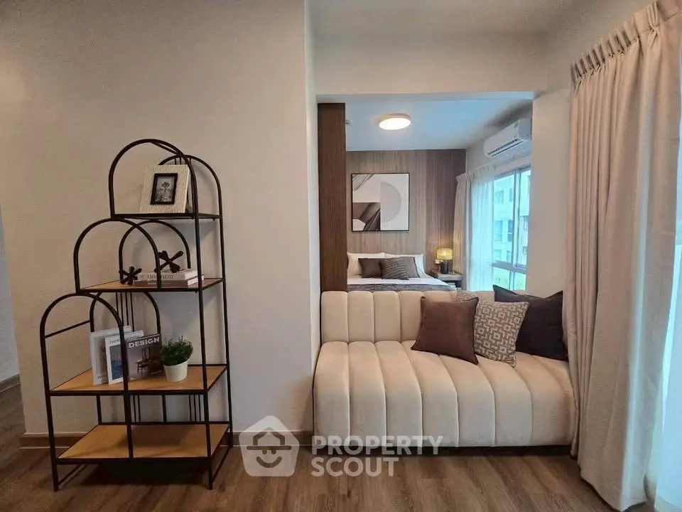 Modern living room with stylish decor and cozy seating area, featuring elegant shelving and natural light.
