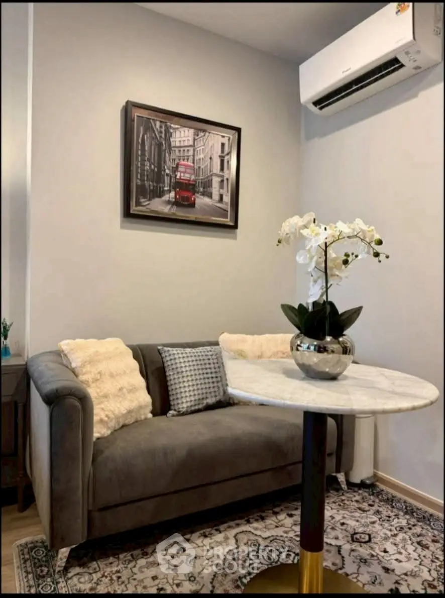 Cozy living room with elegant sofa and air conditioning unit, perfect for relaxation.