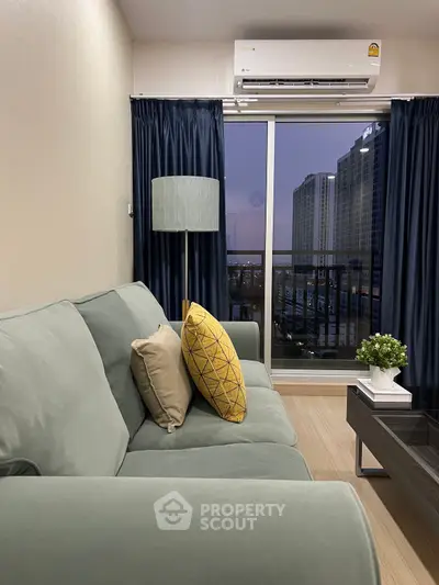 Modern living room with stylish sofa, vibrant cushions, and city view from balcony.