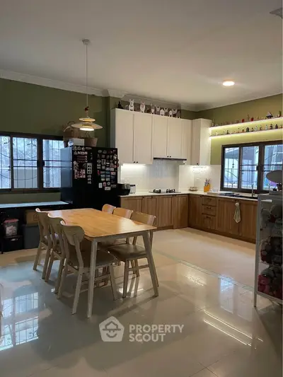 Spacious kitchen with dining area, featuring modern appliances and ample natural light.