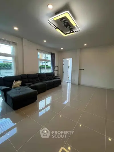Spacious modern living room with sleek tile flooring and stylish lighting