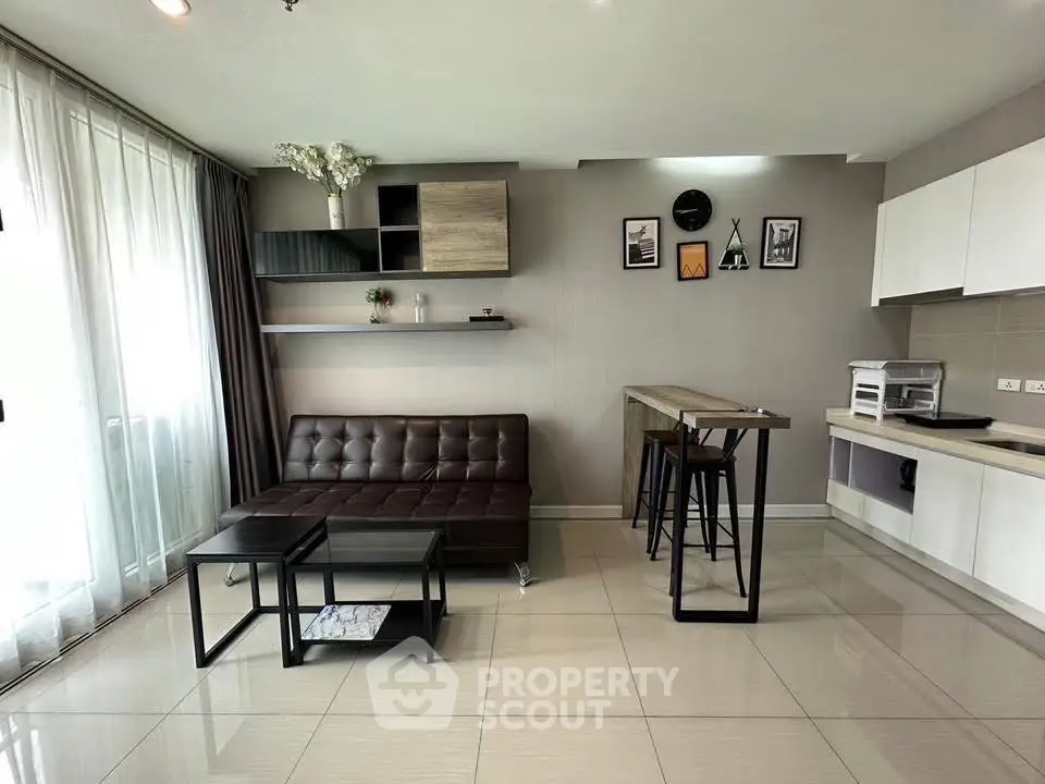 Modern living room with sleek furniture and open kitchen layout